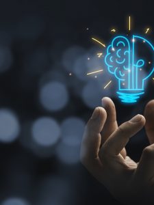 Hand holding drawing virtual lightbulb with brain on bokeh background for creative and smart thinking idea concep Hand holding drawing virtual lightbulb with brain on bokeh background for creative and smart thinking idea concep
